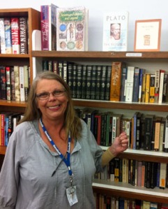 Sales associate Cyndi Alexander points out one of her favorite sections (she really loves them all) in the book nook at the 2800 South Boulevard store.